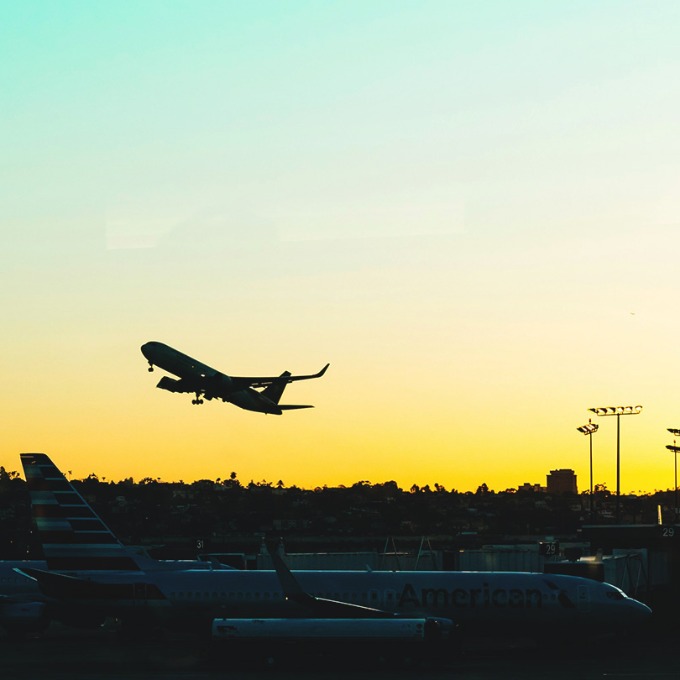 An airplane taking off at sunrise.