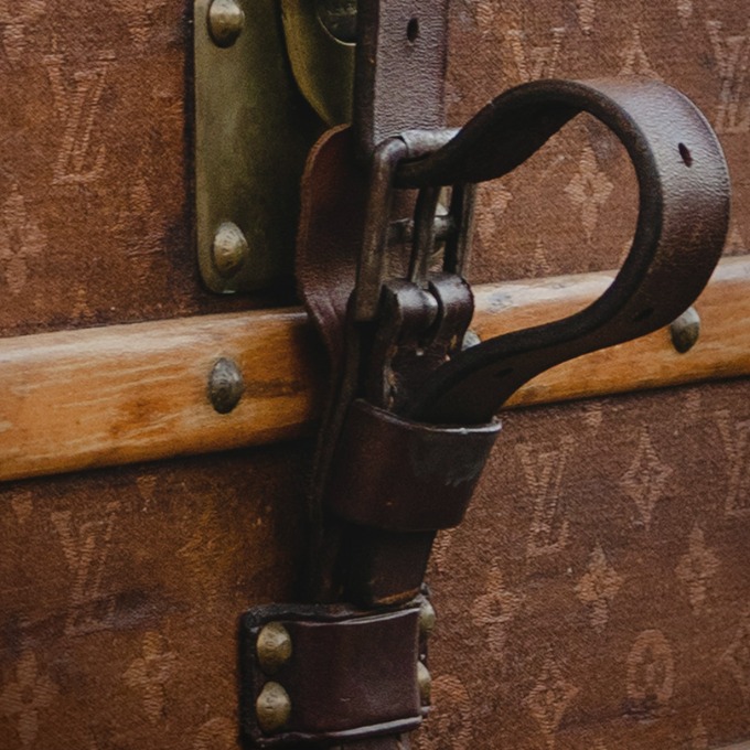 Close up of latch of a Louis Vuitton steamer trunk.