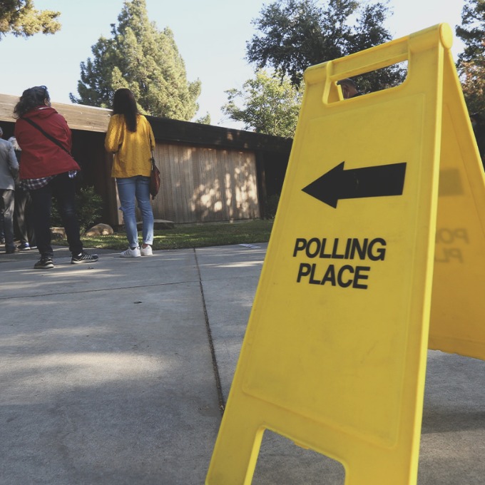 Color photograph of a sign reading "Polling Place" outside a voting location.