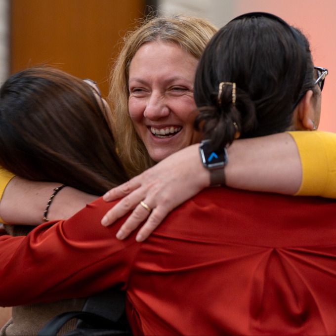 Rahsan Akbulut hugging two colleagues