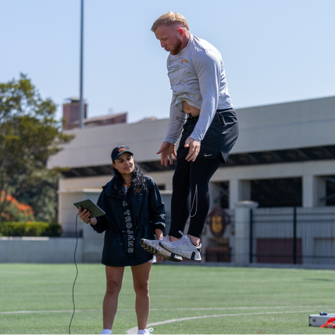 Lorena Martin watching a student jump during a class