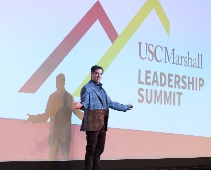 Chad Tons presenting in front of the Leadership Summit logo