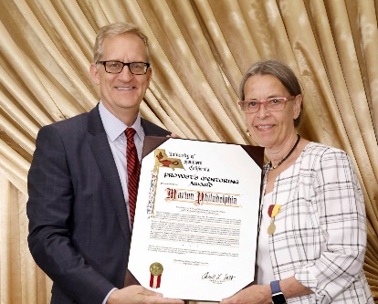 Andrew Guzman presenting Marion Philadelphia with her award.