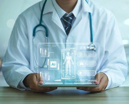 A medical professional is holding a laptop with AI graphics and the human body outline.
