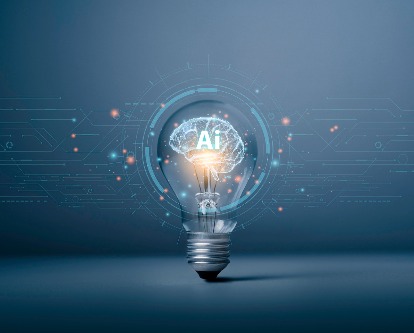 Graphic featuring AI (text) inside a brain inside a lightbulb