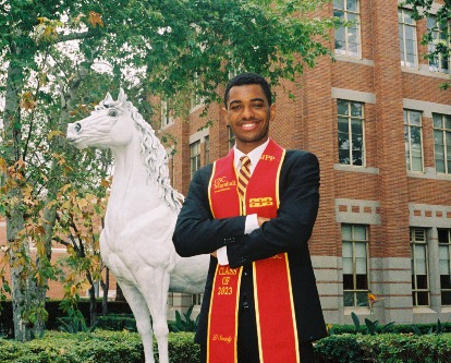 Amir Bell posing in front of Traveler.