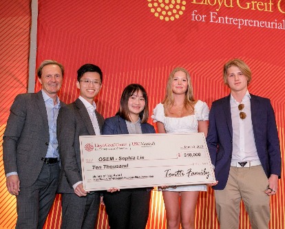 Five people hold large check for winning ATHENA's fifth annual women's pitch competition.