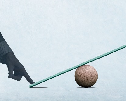 Individual's finger on a balance scale