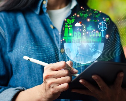 Color photo of a female using a stylus and tablet with a sustainability graphic