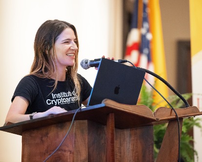 Amanda Cassatt speaks at a podium with her laptop.