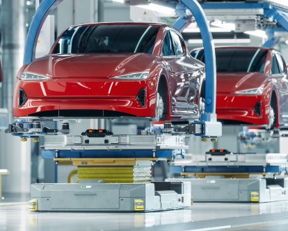 red electric vehicles being made in a factory