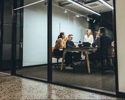 Looking into a conference room where an executive team is holding a meeting.