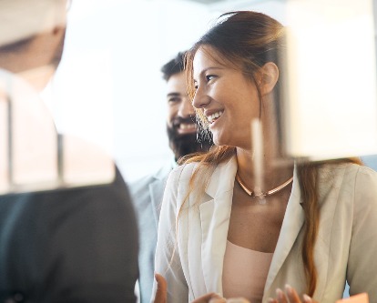 A business woman laughing with her colleagues.
