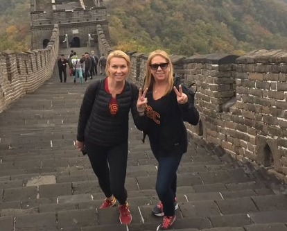 Two women with USC shirts at the Great Wall of China.