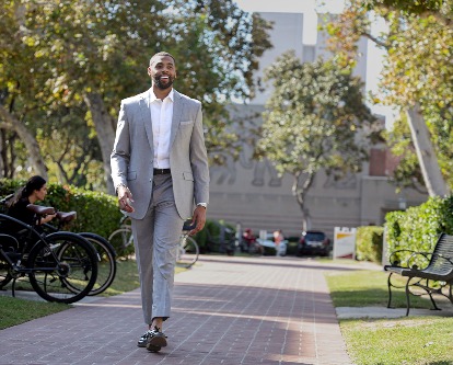 A graduate student walking on the campus of USC.