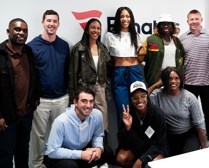 Athletes posing in front of the Fanatics logo