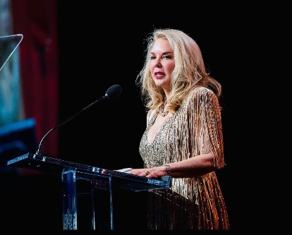 Teena Hostovich gives a speech at a podium