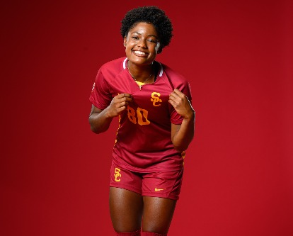 Simone Jackson pointing to the USC logo on her jersey