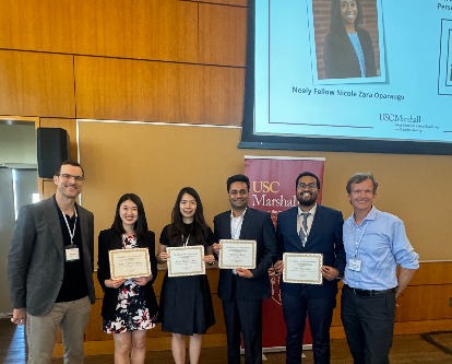 Nate Fast and Carsten Becker posing with the Fellows as they hold their certificates.