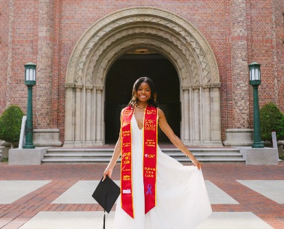 Jackson Dowell posing in her graduation sash