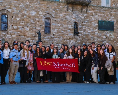 students holding up the Marshall banner in ITaly
