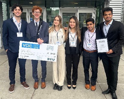 Students hold up a check at the VCIC regional competition.