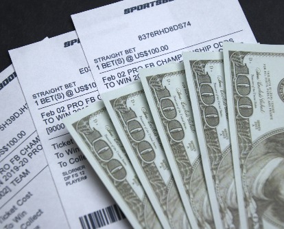 hundred dollar bills on sports betting slips