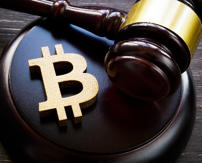 A bitcoin logo next to a gavel