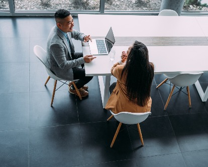 decorative image of a man and woman in the workplace.