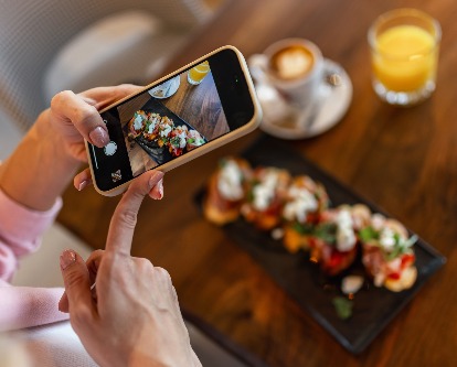 an influencer taking photos of food