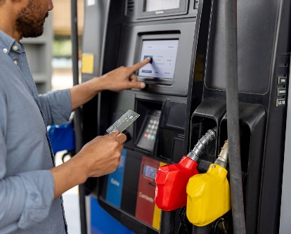 a man paying for gas with a credit card