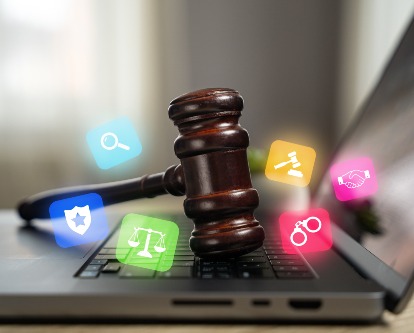 a gavel on a keyboard surrounded by social media icons