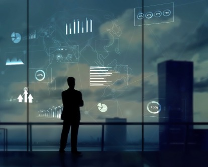 decorative image of businessman staring at graphs by a window