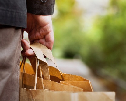 a hand carrying paper bags