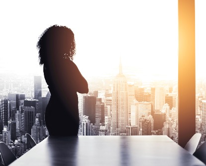 decorative image of person looking at city through window