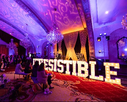A large, lit-up &quot;Irresistible&quot; sign