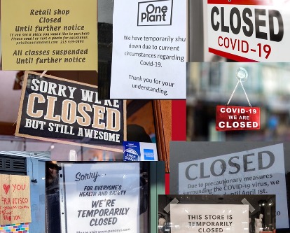A bunch of store fronts with &quot;Closed&quot; signs on them