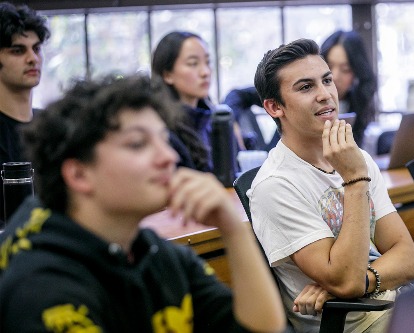 Color photo of students listening to a lecture in a classroom setting