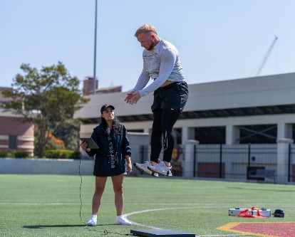Professor Lorena Martin guides student Nick Adgar in a sports assessment test