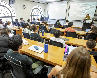 Students in a classroom listen to a lecture.