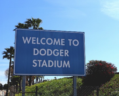Color photograph of blue sign reading &quot;Welcome to Dodger Stadium&quot; on a sunny day.