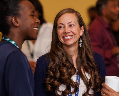 Three female-presenting members of the USC Marshall community talking at a conference.