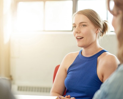 A student speaking amongst peers.