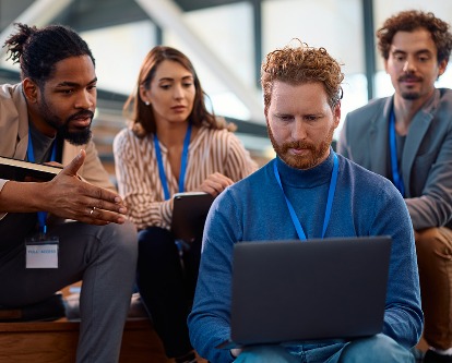 A business team working together on a laptop.