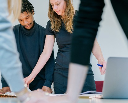 Two colleagues reviewing work in a creative office space.