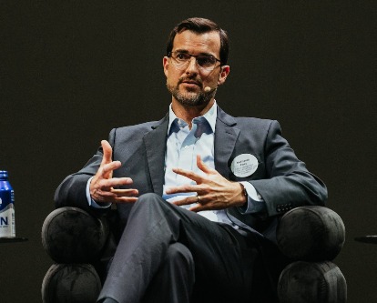 Nathanael Fast speaking during a panel discussion