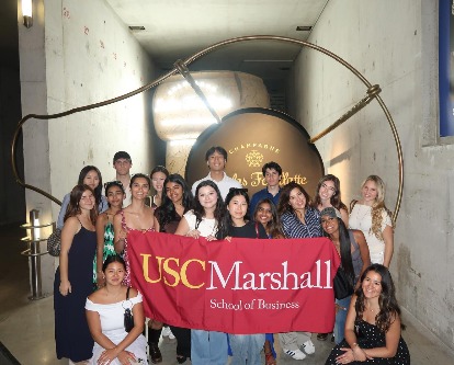 ExCEL students posing with the Marshall flag at nicolas feuillatte