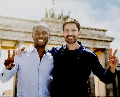 Two graduate students flashing the USC Fight On! hand sign in Berlin.