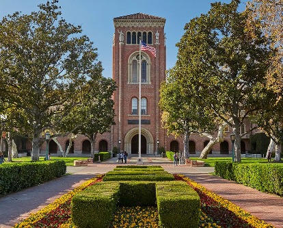 Exterior of campus buildings and floral walkway.