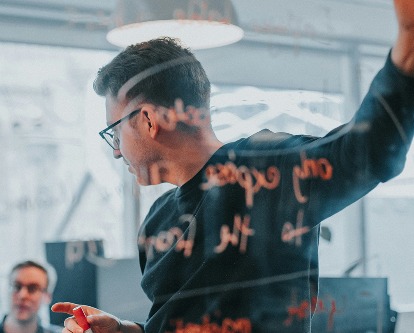 A male-presenting graduate student in a workshop.